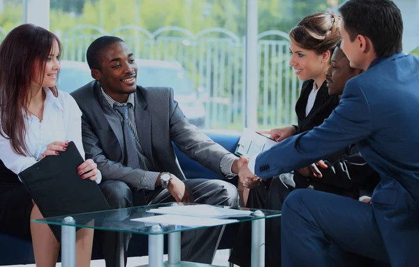 Two business man shaking hands with his team in office. — Stock Photo, Image