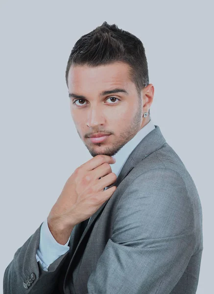 Portrait of a stylish young man standing with hands folded over white background. — Stock Photo, Image