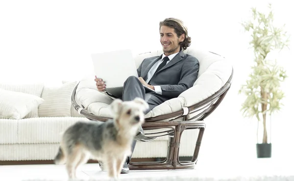 Homme d'affaires moderne avec ordinateur portable assis dans le salon . — Photo