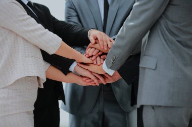 Business team joining hands together.
