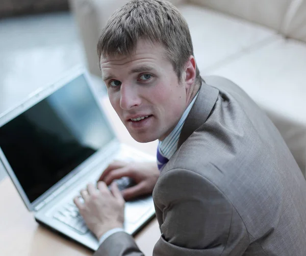 Top view of young man in suit suit working on laptop — Stock Photo, Image