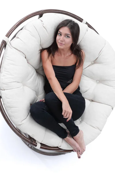 Smiling young woman resting in big soft armchair — Stock Photo, Image