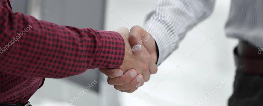 Closeup of a business hand shake between two colleagues