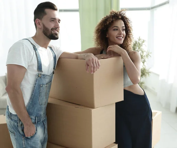 Casal de pé ao lado de caixas quando se mudar para uma nova casa — Fotografia de Stock