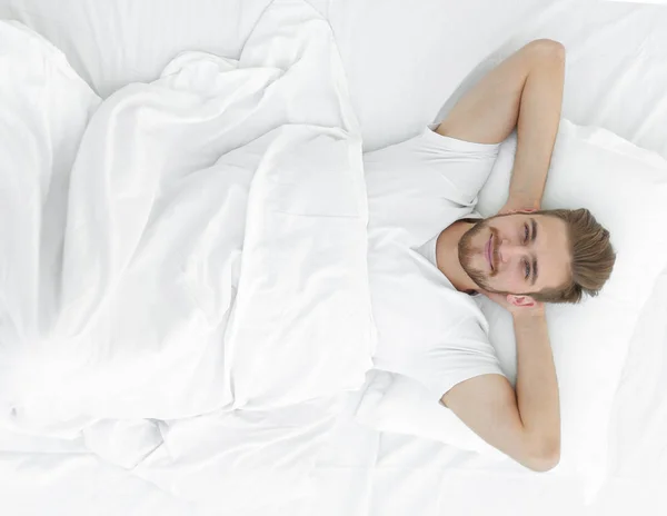 Top view.smiling man relaxing on the couch — Stock Photo, Image