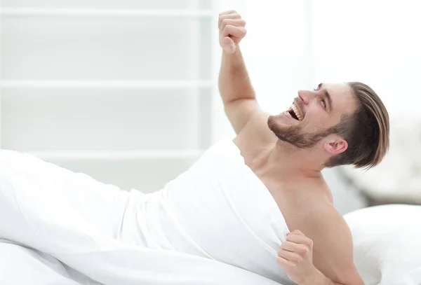 Smiling man waking up in the morning — Stock Photo, Image