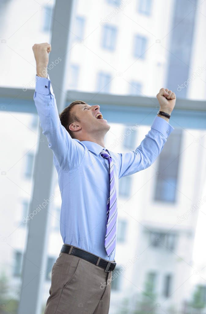 Businessman celebrating with his fists raised in the air