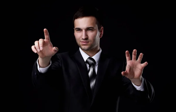 Businessman pointing to a blank spot.isolated on a black background. — Stock Photo, Image