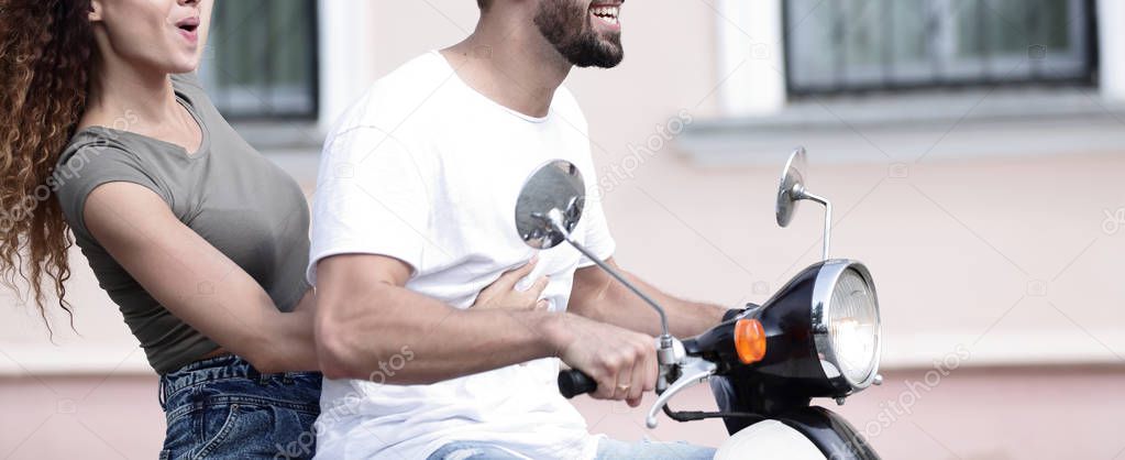 Cool man and beautiful girl riding on  scooter with  expression
