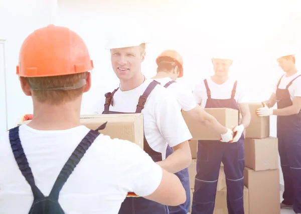 Group of people builders with boxes — Stock Photo, Image