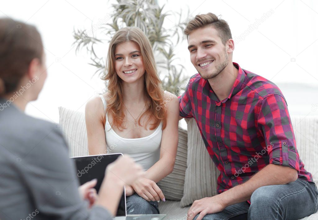 Young happy couple at therapy session with family psychologist