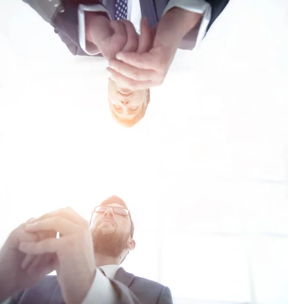 View from below. From behind the glass. Two businessmen sitting at the table.