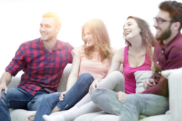 Group of cheerful friends sitting on the couch — Stock Photo, Image