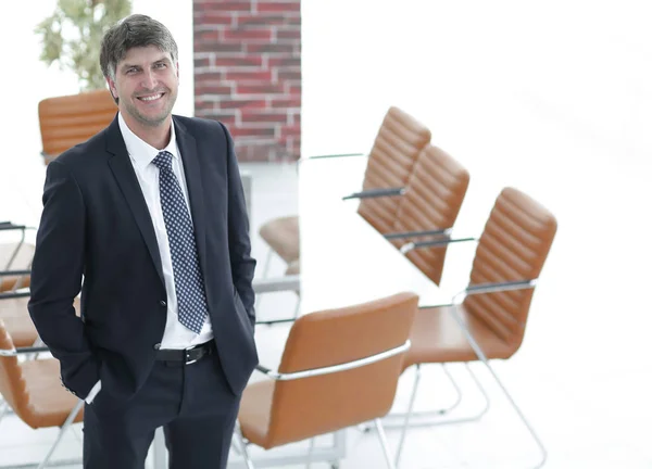 Business man standing in an empty meeting room — Stock Photo, Image