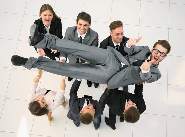 Triumphant business team shakes their leader — Stock Photo, Image