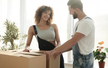 Yeni evliler yeni bir daire kutularına taşımak.