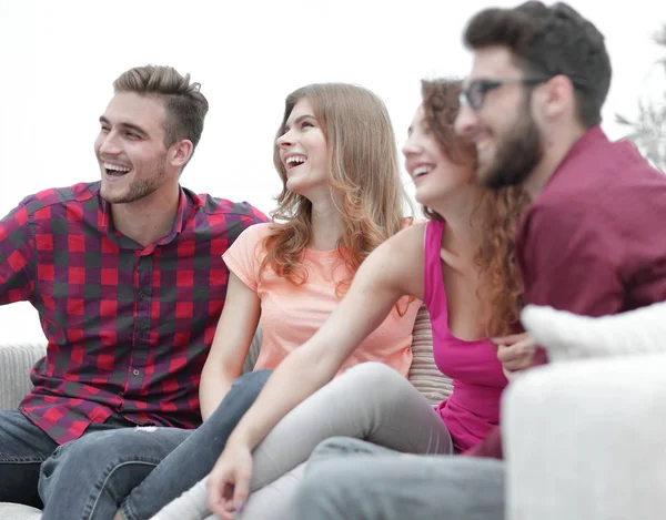 Group of cheerful friends sitting on the couch — Stock Photo, Image