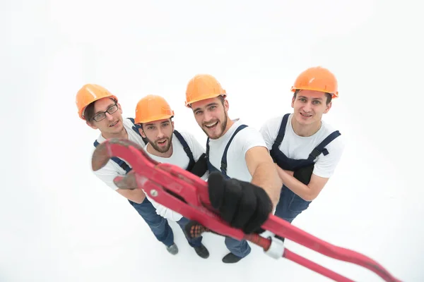 View from the top.group of builders showing a gas key. — Stock Photo, Image