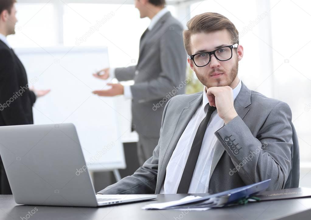 successful businessman sitting at Desk in office