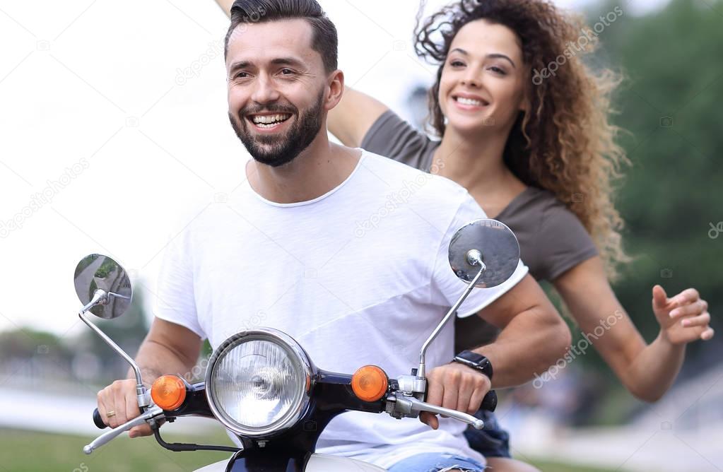 Happy couple driving scooter excited on summer holidays vacation