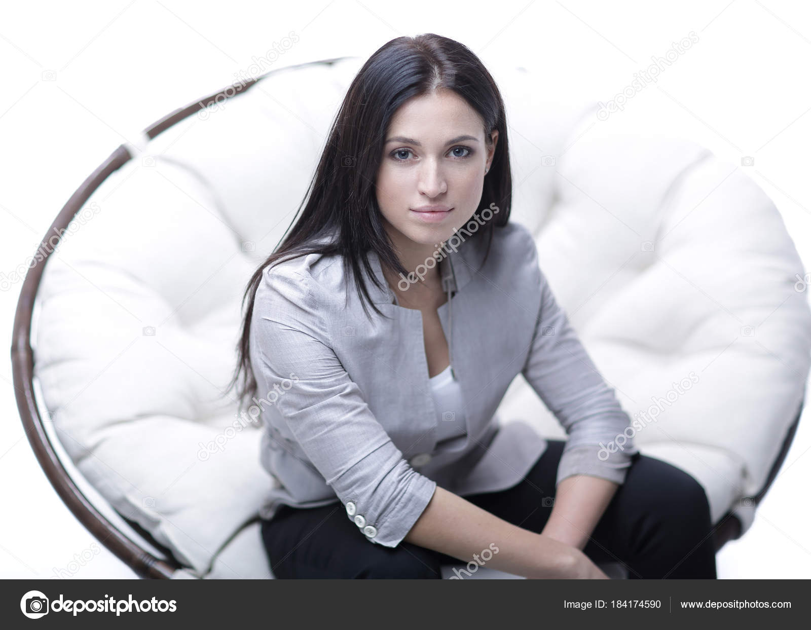 Young Woman Sitting In A Round Cozy Soft Big Chair Stock