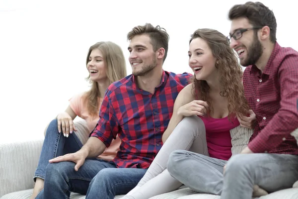 Young friends sitting on the couch and rooting for their favorite team — Stock Photo, Image