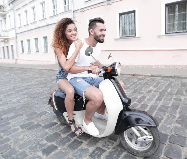 Full length side view of happy couple riding on retro motorbike — Stock Photo, Image