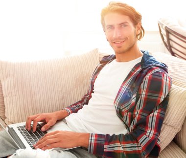 dizüstü bilgisayar ile ciddi genç adam.