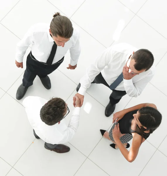 View from the top. colleagues shaking hands in office lobby. — Stock Photo, Image