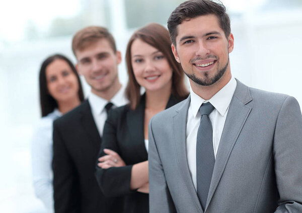 leader and the business team standing one behind the other.