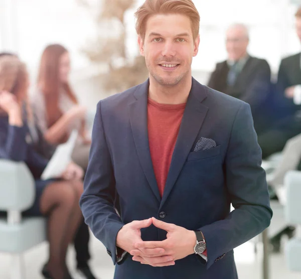 Successful businessman on blurred background business team. — Stock Photo, Image