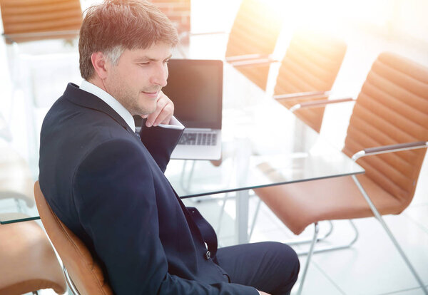 Boss sitting in the workplace before the meeting