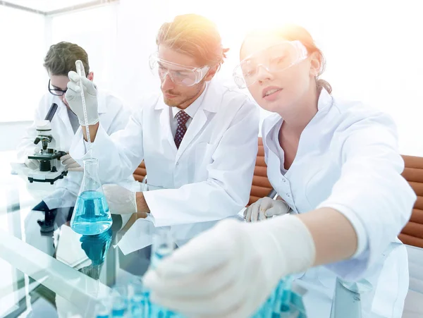 Scientist holding test tube or some equipment of science — Stock Photo, Image