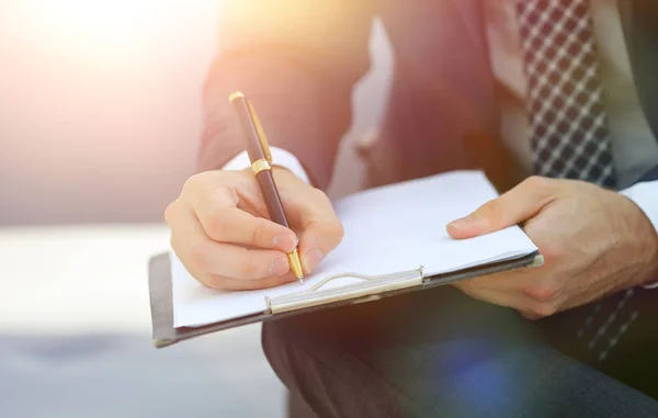 Affärsman tecknar avtal. Håller pennan i hand. — Stockfoto