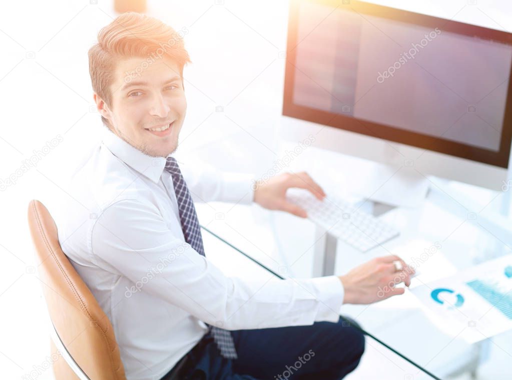 employee sitting in front of a computer screen