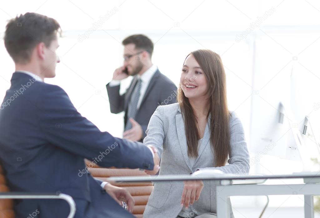 business woman shaking hands with a business partner.