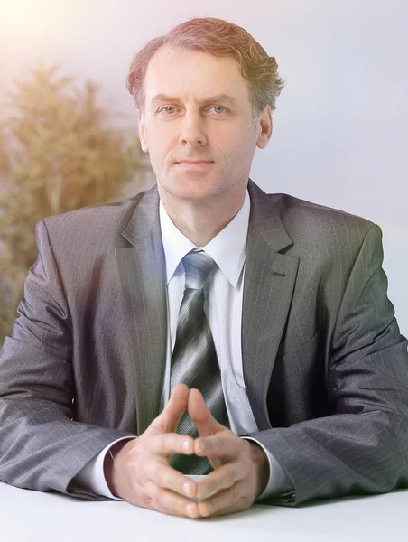 Portrait of businessman sitting at the desk — Stock Photo, Image