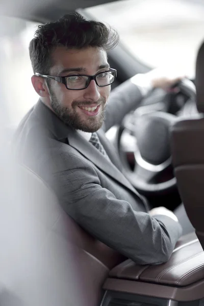 Man in formalwear sitting in car — Stock Photo, Image