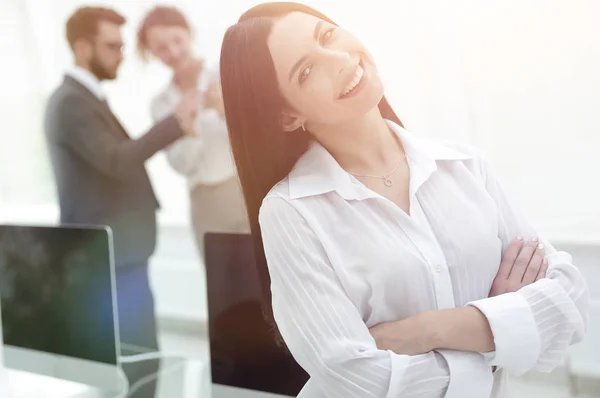 Giovane donna d'affari di successo sullo sfondo di un posto di lavoro — Foto Stock