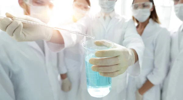 Closeup of a group of medical workers working with liquids — Stock Photo, Image