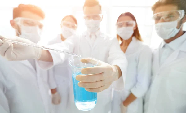 Closeup of a group of medical workers working with liquids — Stock Photo, Image