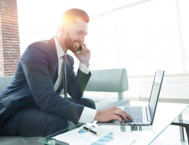 Smartphone üzerinde konuşmak ve metin dizüstü bilgisayarda yazarak işadamı