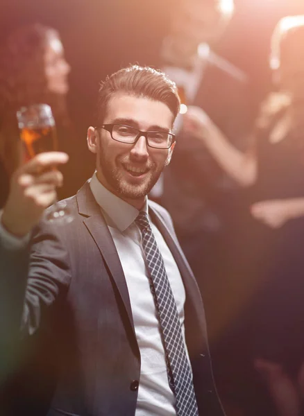 Elegant man raising a glass of champagne — Stock Photo, Image