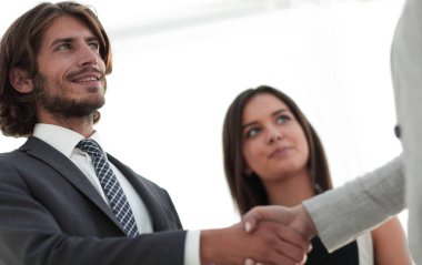 İş adamları geniş pencereli odaya karşı el sıkışıyor