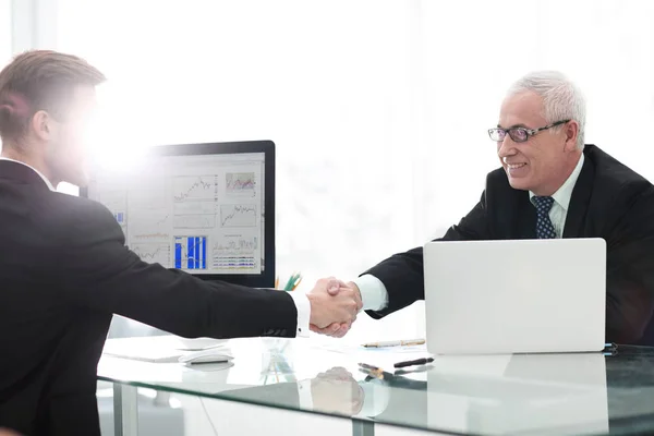 businessman welcomes business partner shaking hands