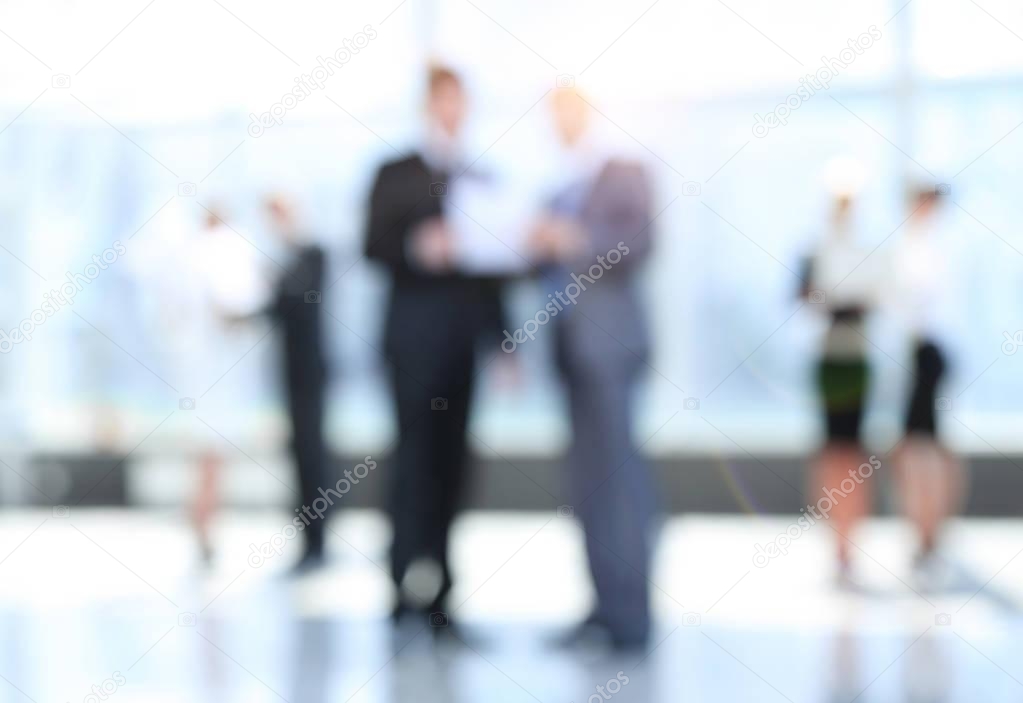 business background.blurred image of business people standing in