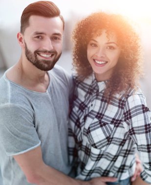 mutlu genç çift birbirlerine sarılıyor.