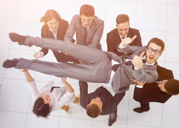 Triumphant business team shakes their leader — Stock Photo, Image