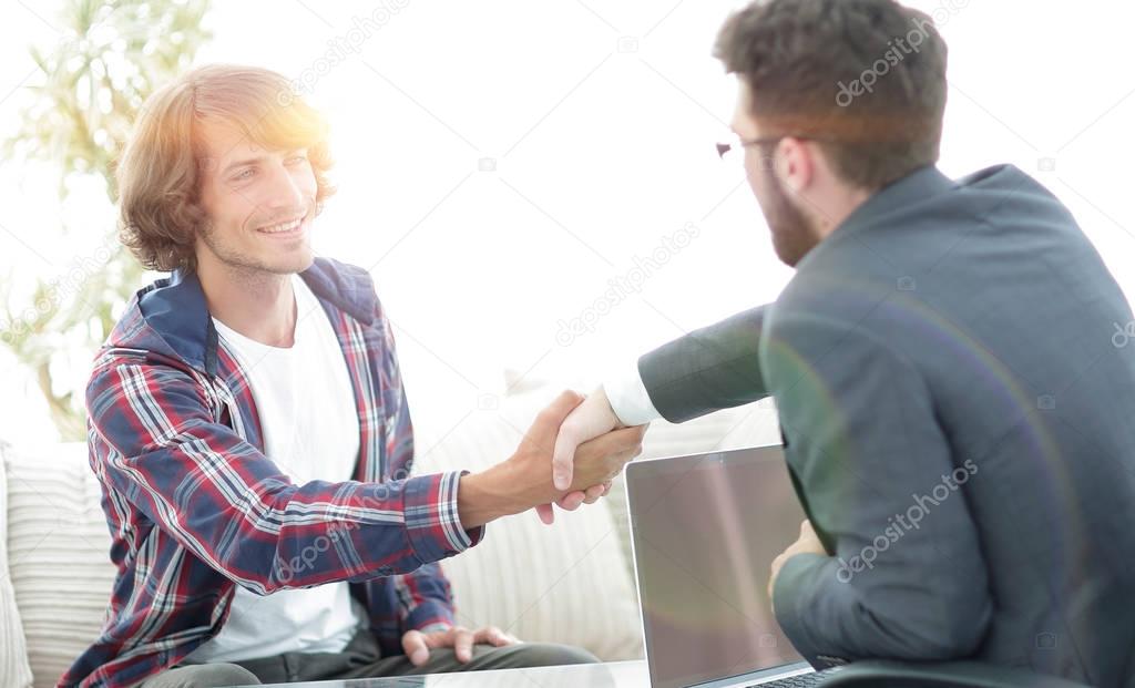 manager shakes hands with his client