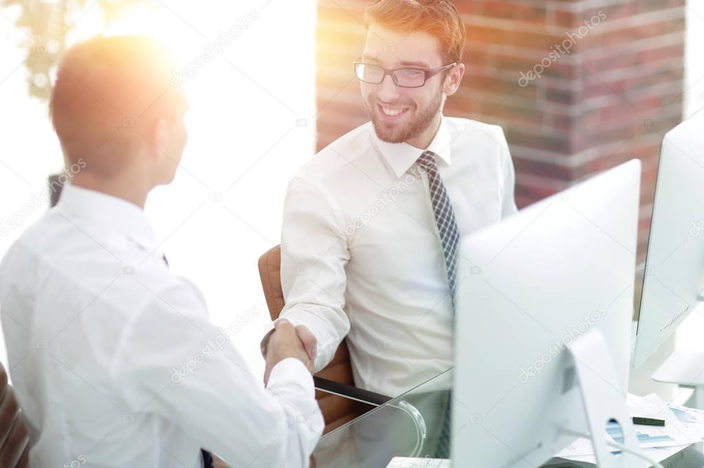 handshake Manager and customer in a modern office
